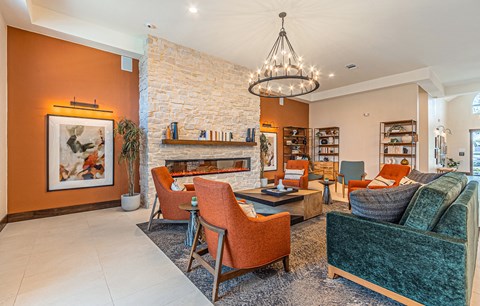 a living room with couches and chairs and a fireplace